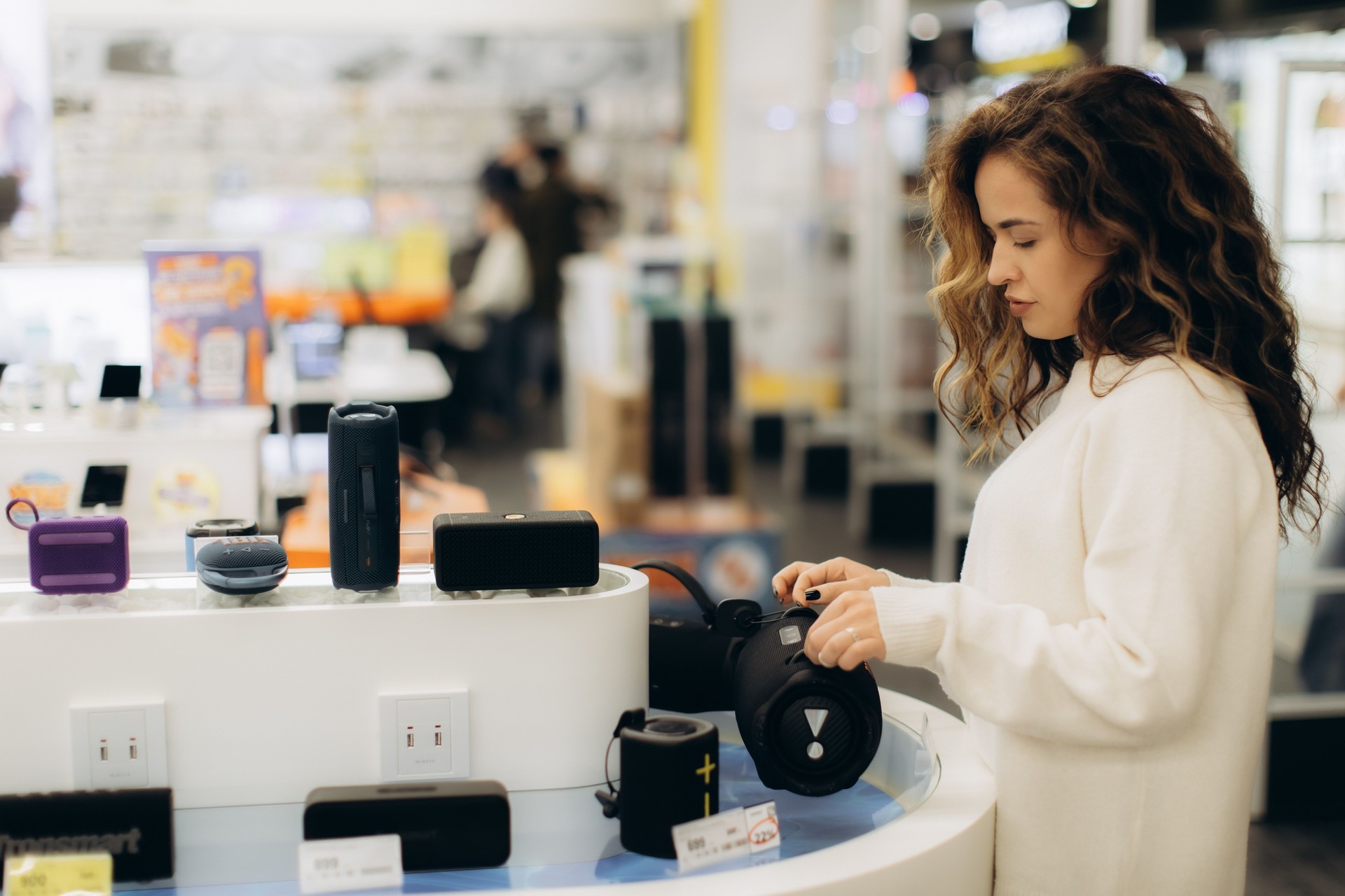 Young Woman Shopping for Electronics in a Modern Retail Store